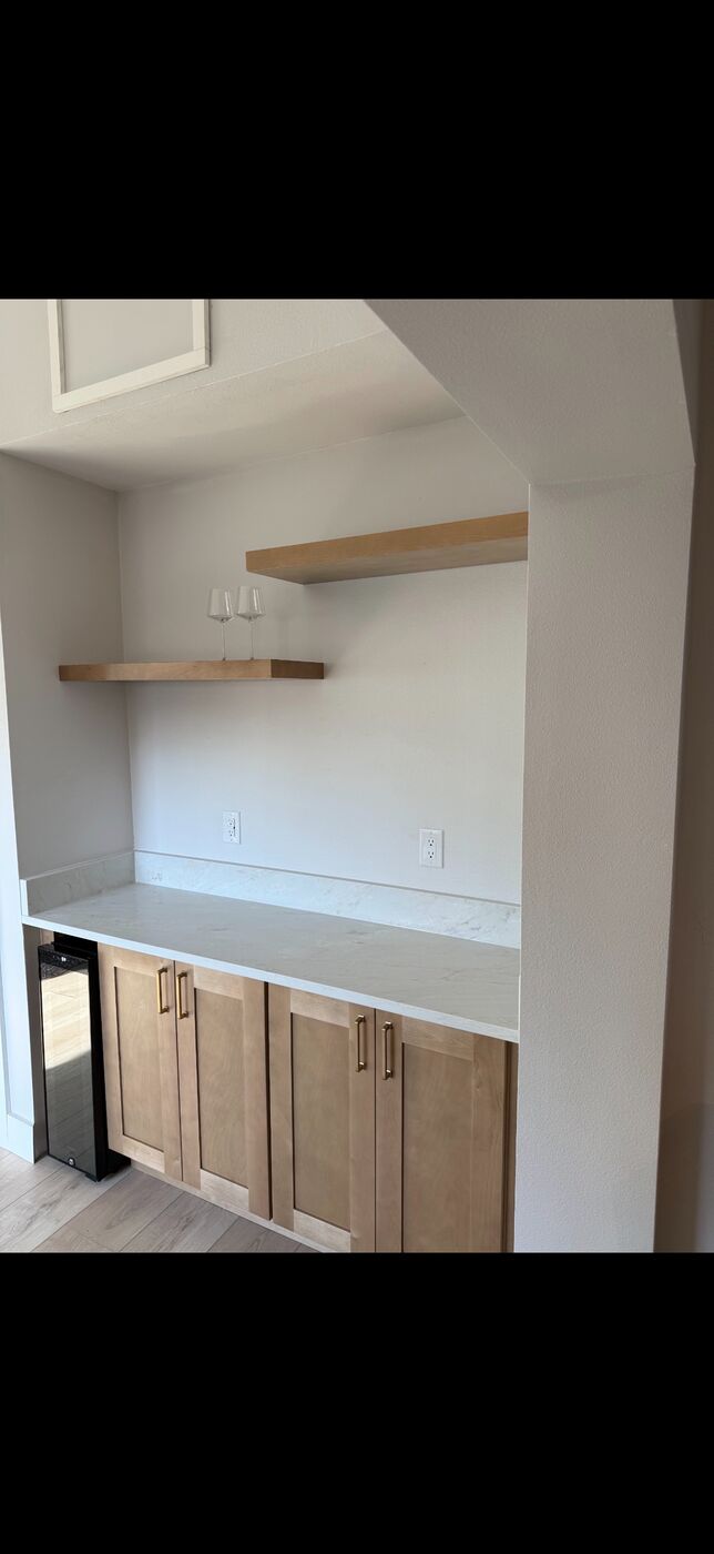 Built-in dry bar with shaker cabinets and beverage cooler