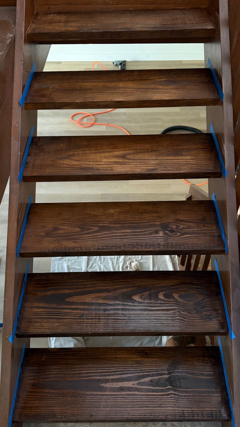 Staircase with freshly stained treads taped off